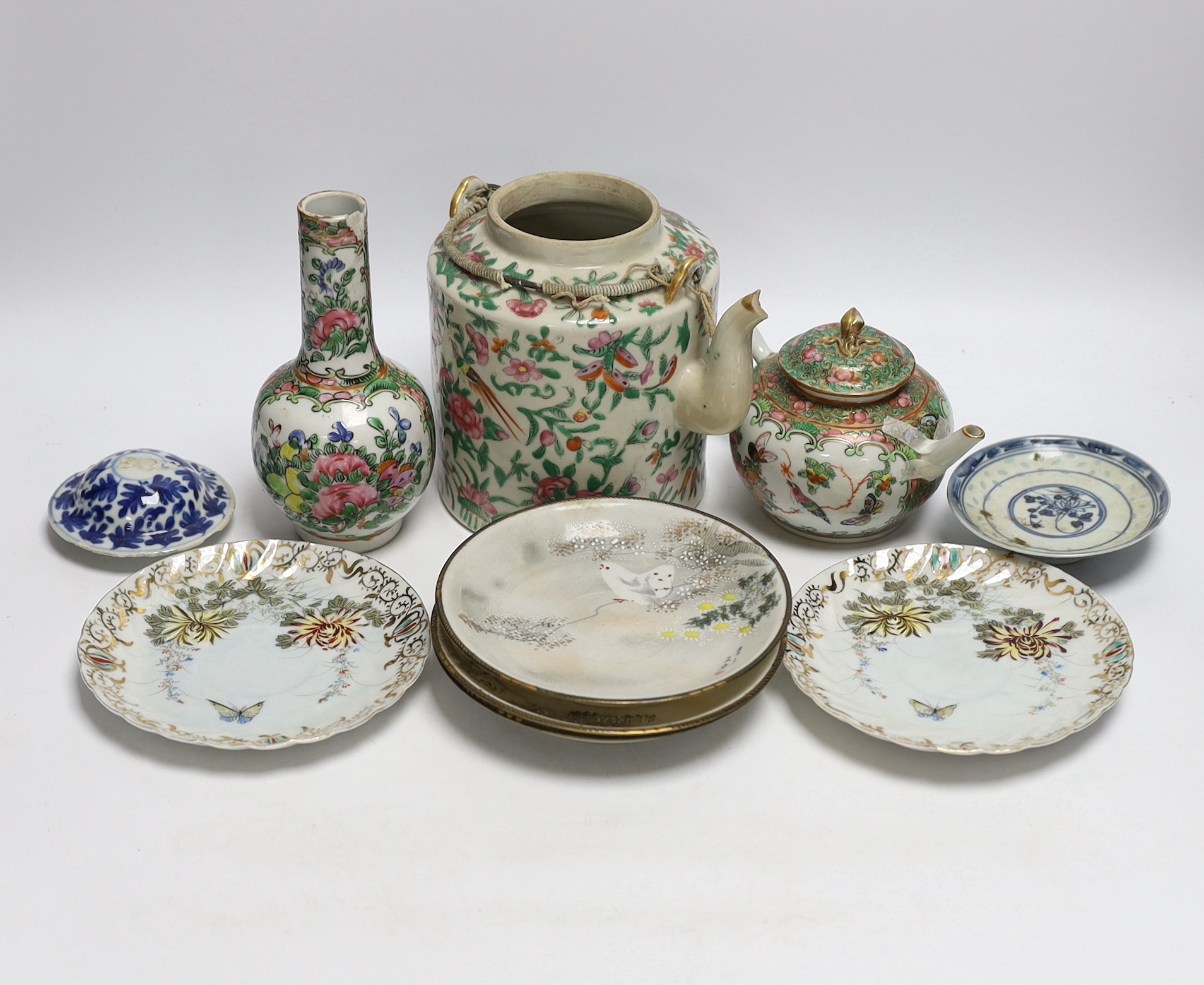 A collection of Chinese and Japanese ceramics including two famille rose teapots, a vase, four saucers, etc. (8)